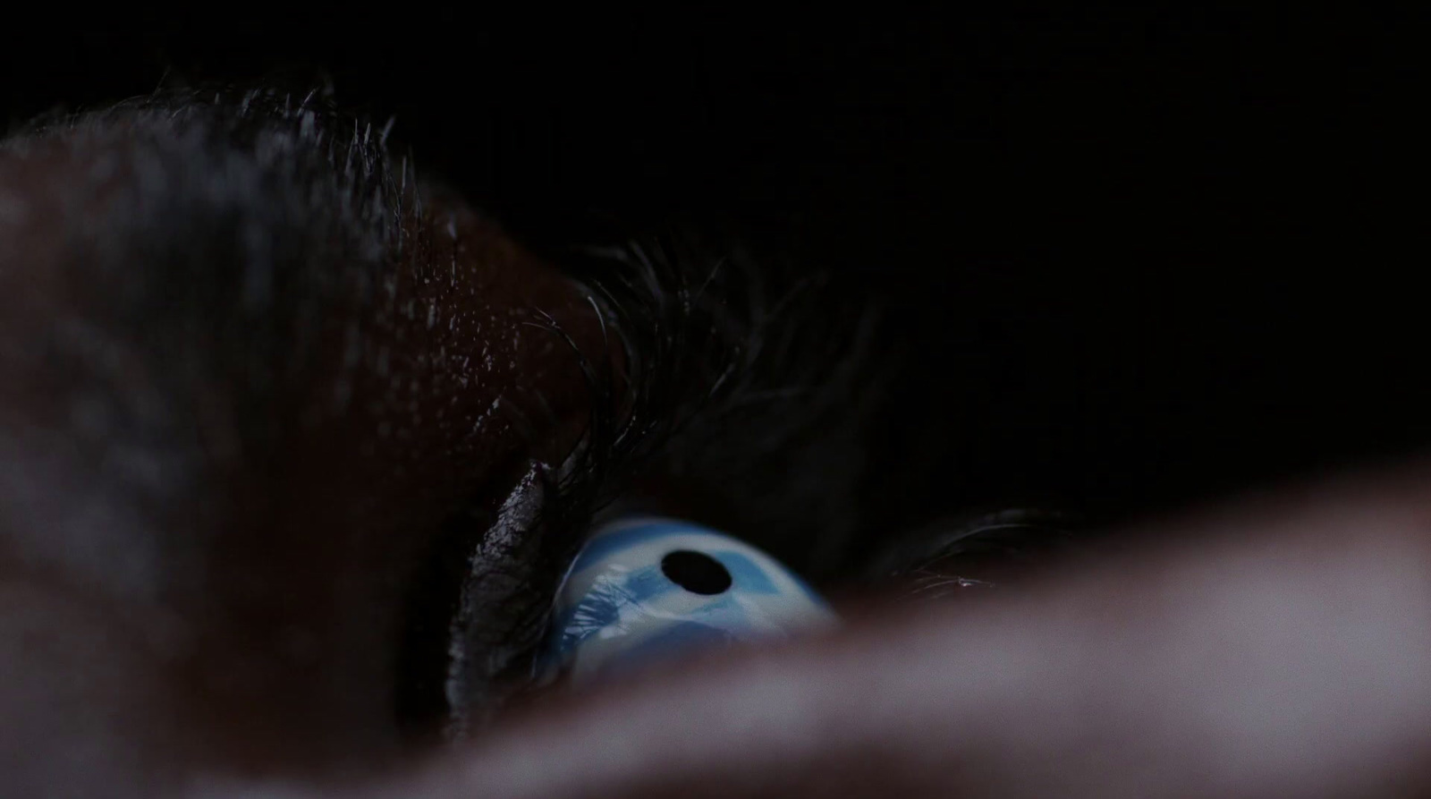 a close up of a person's eye in the dark