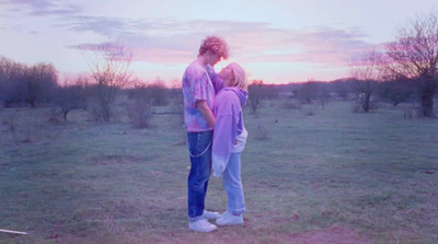 a man and a woman standing in a field