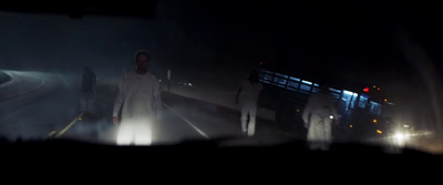 a group of people standing on a road at night