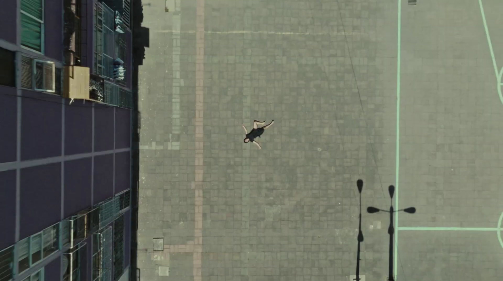 an aerial view of a basketball court and a person on a skateboard