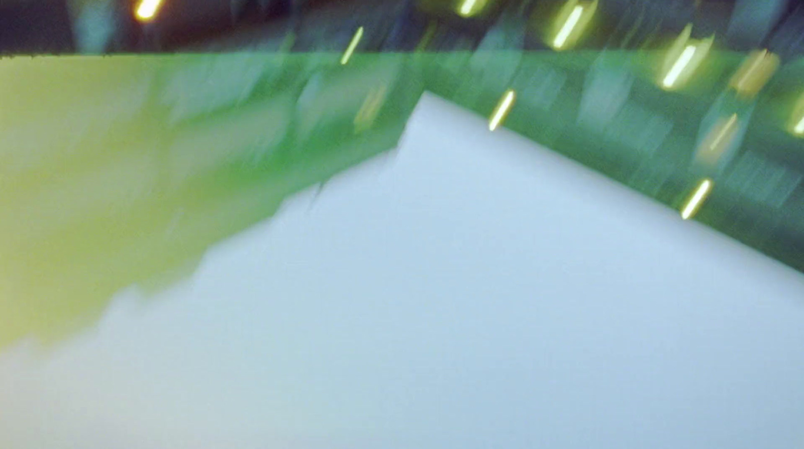 a blurry photo of a white table with a green background