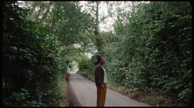 a woman standing in the middle of a road