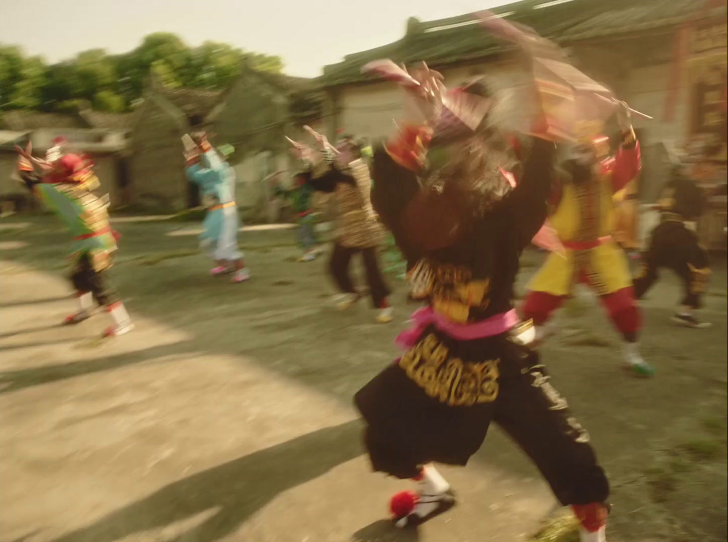 a group of people are dancing in a courtyard