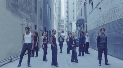 a group of people standing on a city street