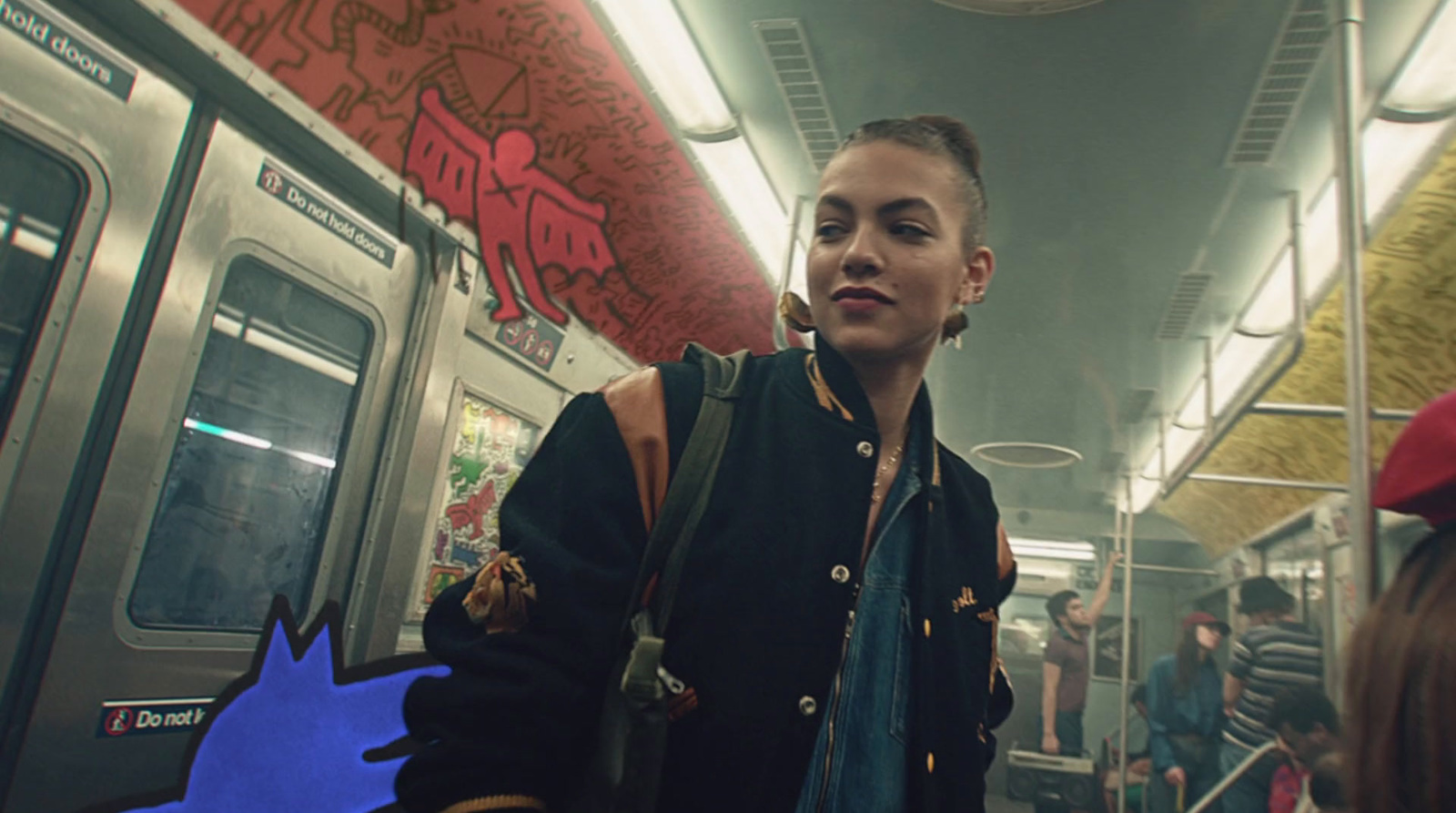 a woman standing on a subway train next to a man