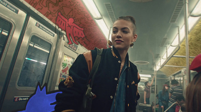 a woman standing on a subway train next to a man