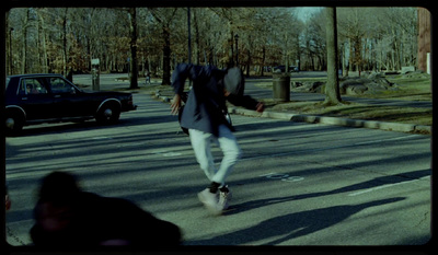 a man riding a skateboard down a street