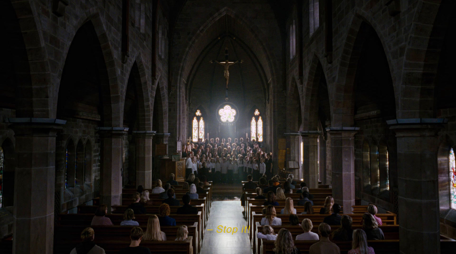 a church filled with people sitting in pews