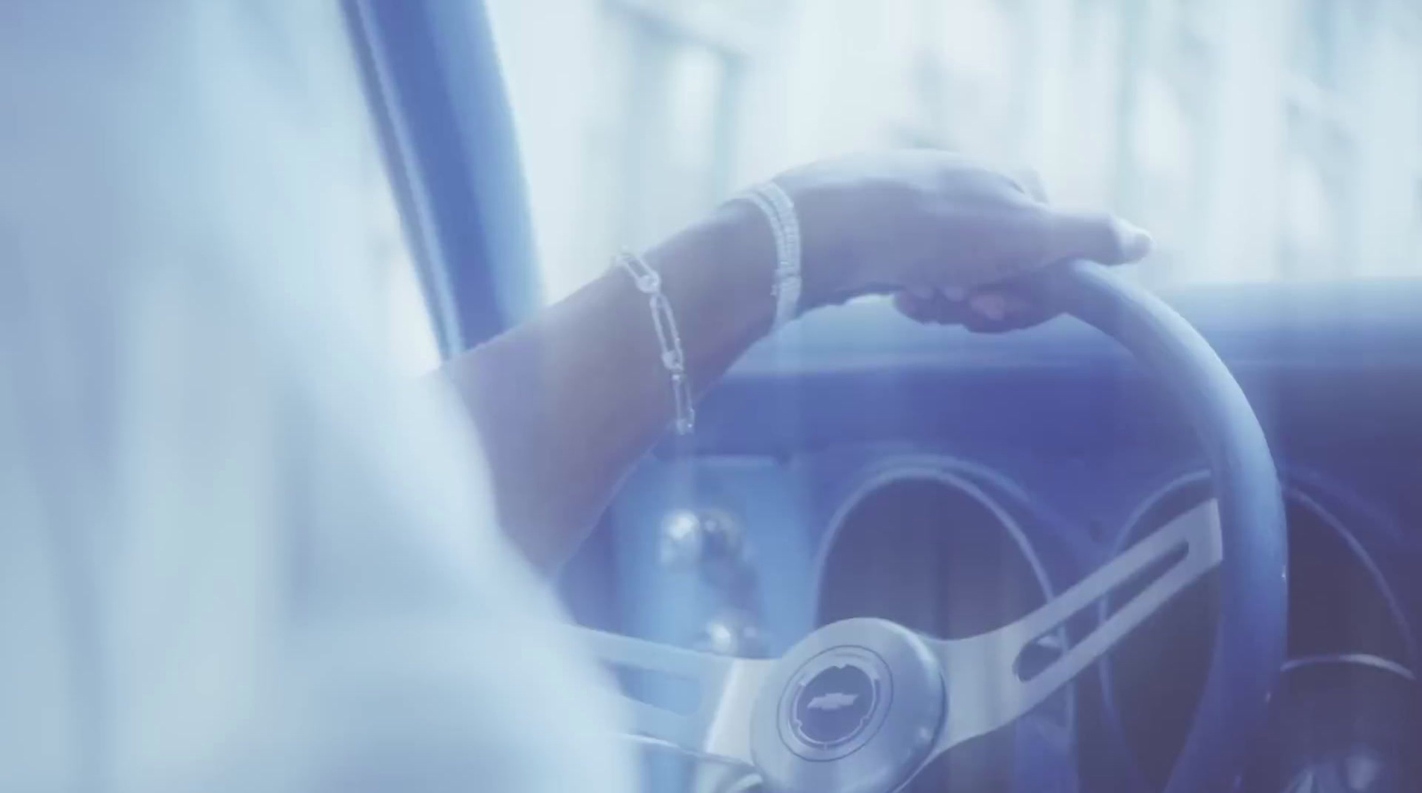 a person holding a steering wheel while driving a car