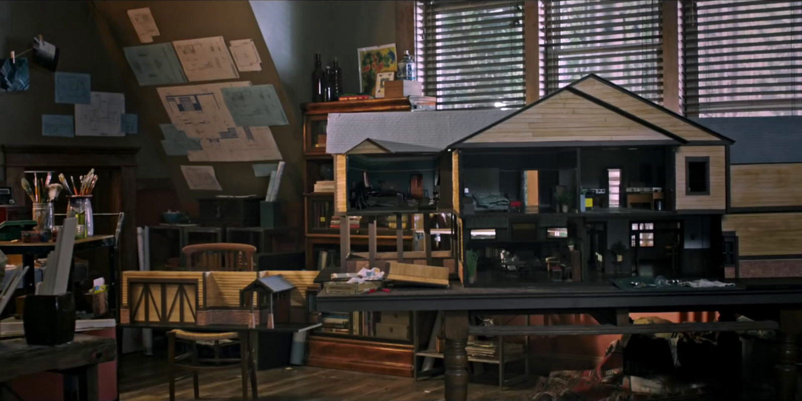 a doll house sitting on top of a wooden table