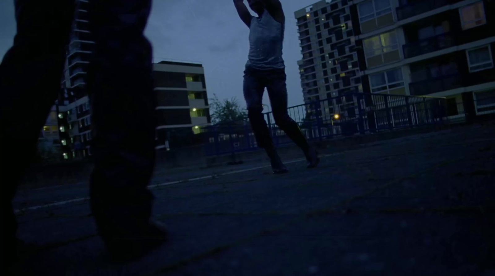 a person holding a frisbee in the dark