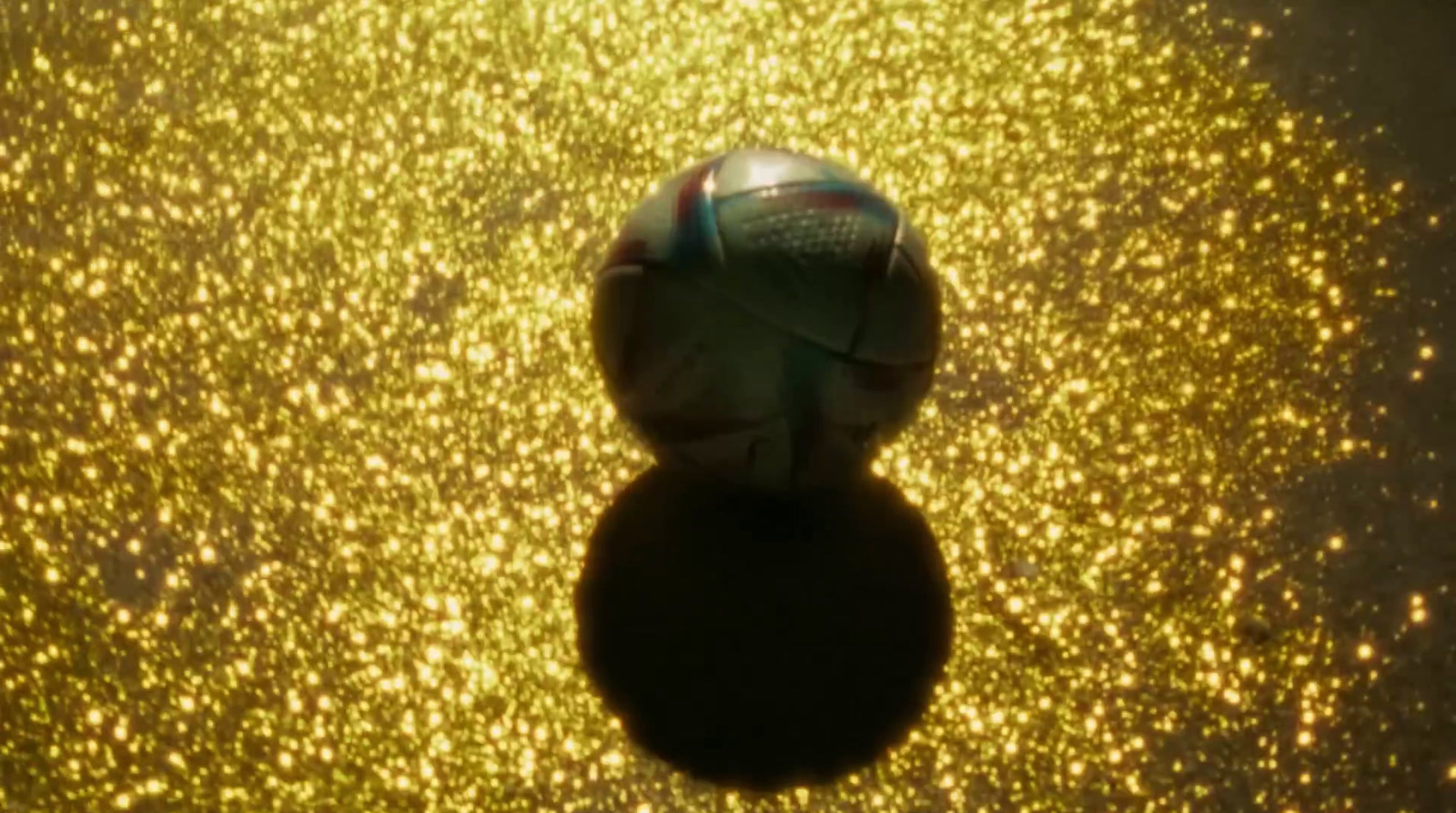 a soccer ball sitting on top of a shiny surface