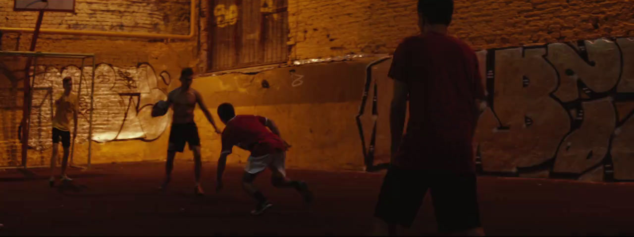 a group of young men playing a game of basketball