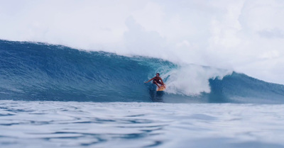 a man riding a wave on top of a surfboard