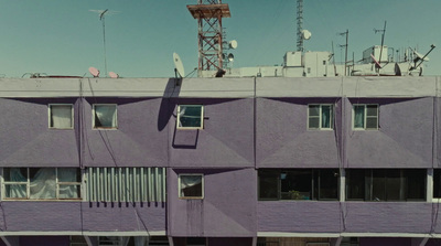 a tall purple building with lots of windows