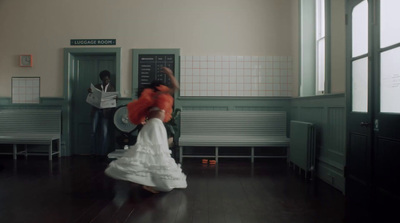 a woman in a white dress dancing in a room