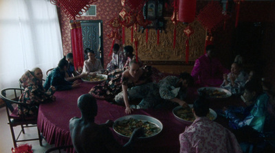 a group of people sitting around a table eating food