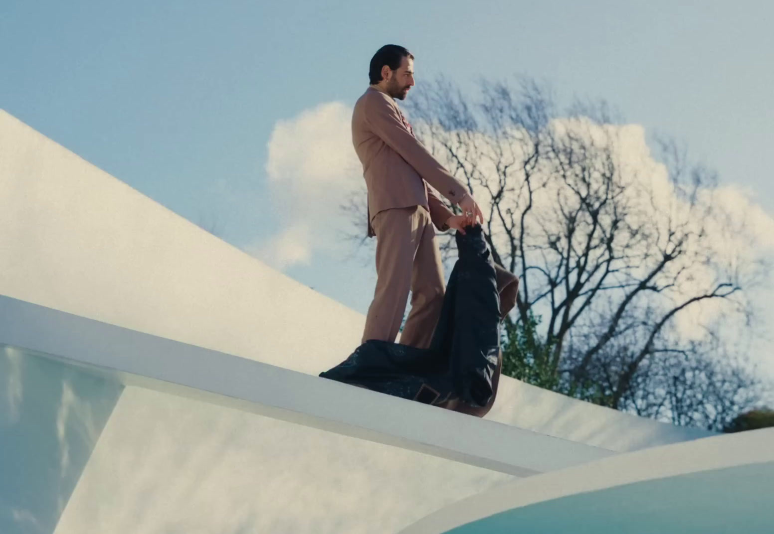 a man in a suit is standing on a ledge