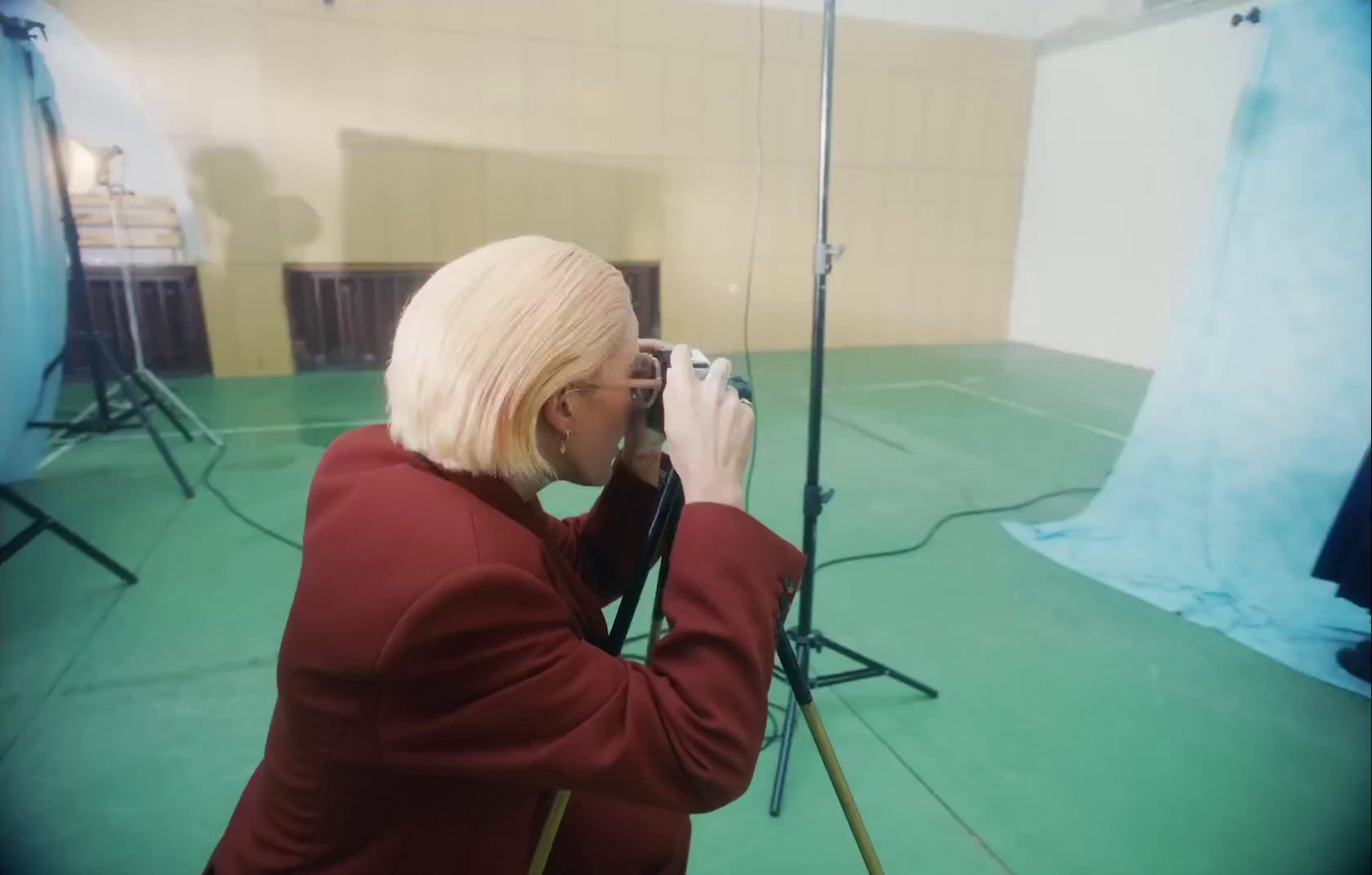 a woman taking a picture in a photo studio