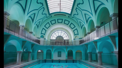 a large indoor swimming pool with a skylight