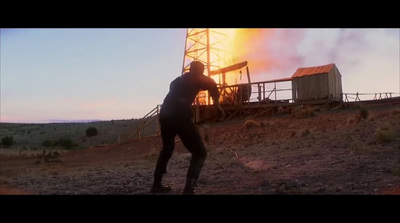 a man standing in front of a burning building