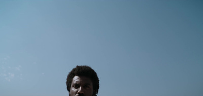 a man standing on a beach holding a frisbee