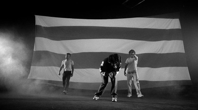 a group of people standing in front of a large flag