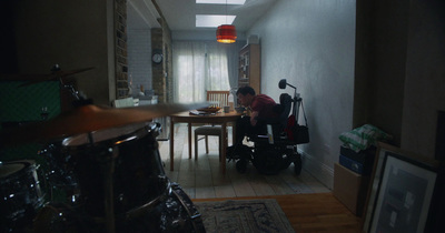 a man sitting in a wheel chair in a room