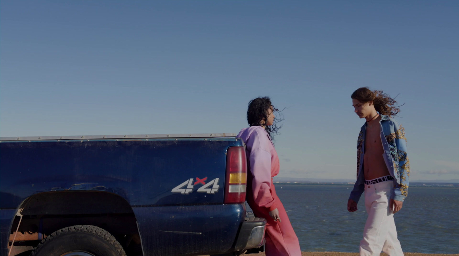 a couple of people standing next to a truck