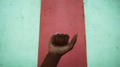 a hand is pointing at a red and white striped wall