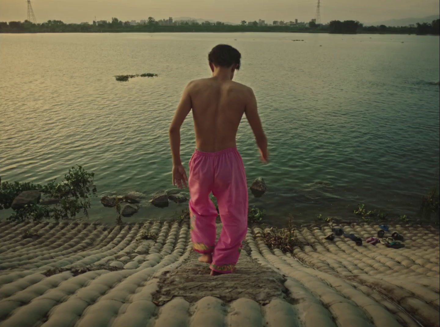 a man standing on a rock near a body of water