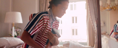 a woman standing in front of a mirror in a bedroom