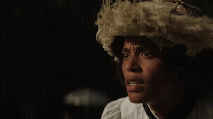 a man wearing a white shirt and a large hat