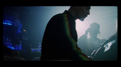 a man standing in front of a microphone in a dark room