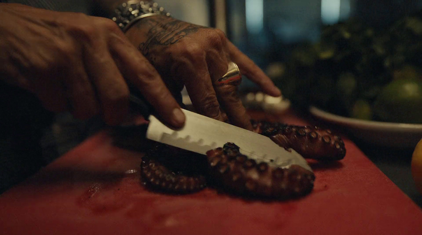 a person cutting up some food on a cutting board