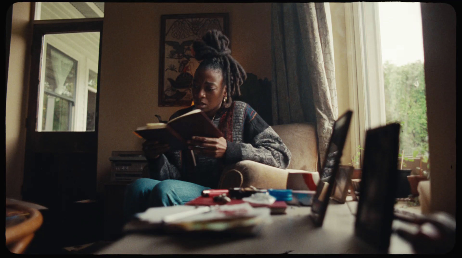 a woman sitting in a chair reading a book