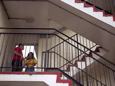 a man and a woman standing on a stair case