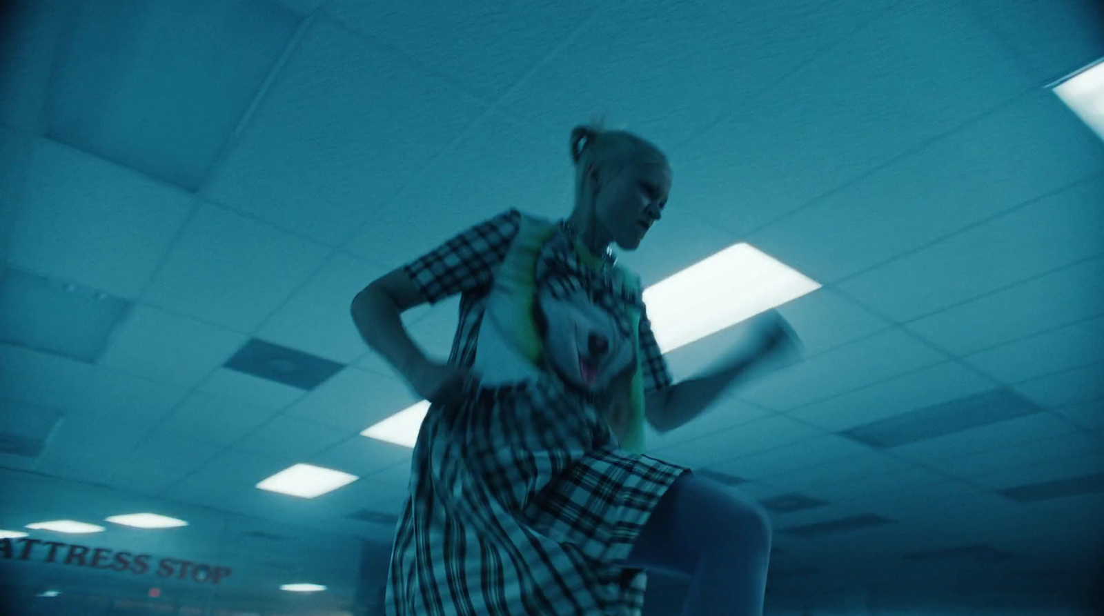 a woman standing in a room holding a frisbee