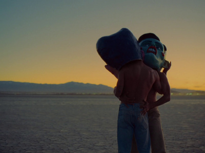 a couple of people standing on top of a beach