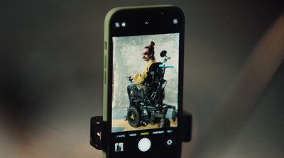 a cell phone with a picture of a man in a wheelchair