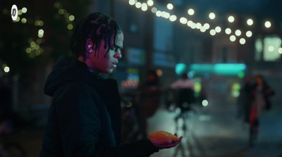 a man with dreadlocks holding a piece of fruit