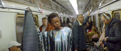 a group of people standing on a subway train