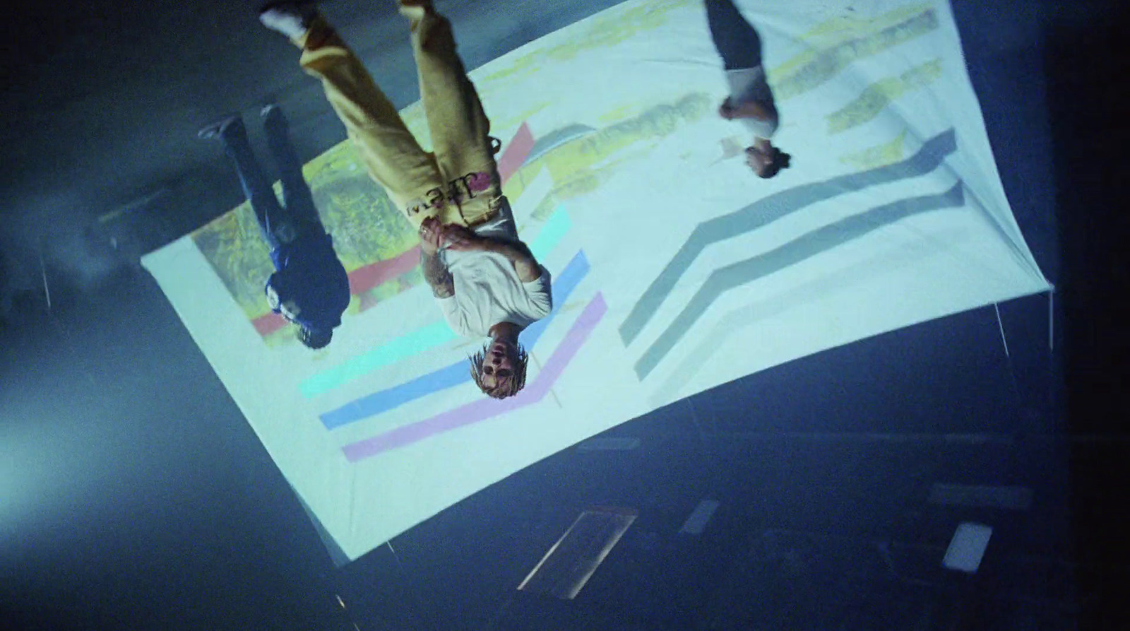 a person doing a handstand on a large sheet of paper