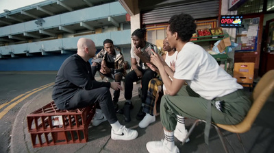 a group of men sitting around each other