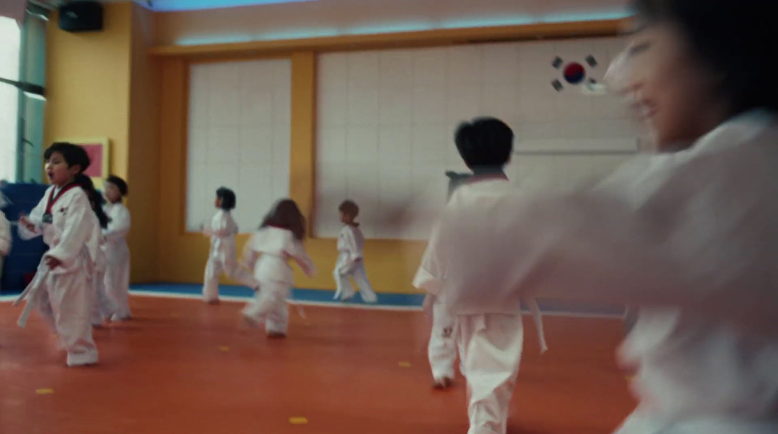 a group of young people practicing karate in a gym