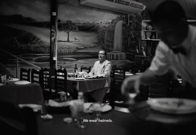 a man sitting at a table with a plate of food