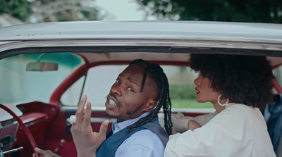 a man and a woman sitting in a car