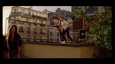 a couple of people that are standing on a ledge