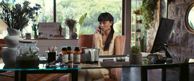 a woman sitting in a chair talking on a cell phone