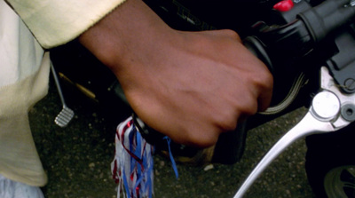 a close up of a person's hand on a motorcycle